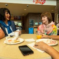 President Mantella talking with families seated in Kirkhof Center during pancake breakfast.